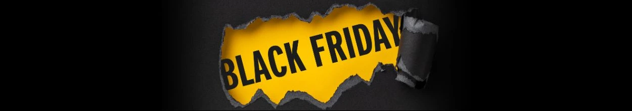 Scritta "black friday" su sfondo giallo che compare da sotto un foglio nero strappato