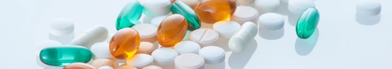 Insieme di pillole di diversi colori che rappresentano la categoria di Health e Pharma